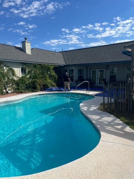 Completed storm damage roof repair on a home with a pool